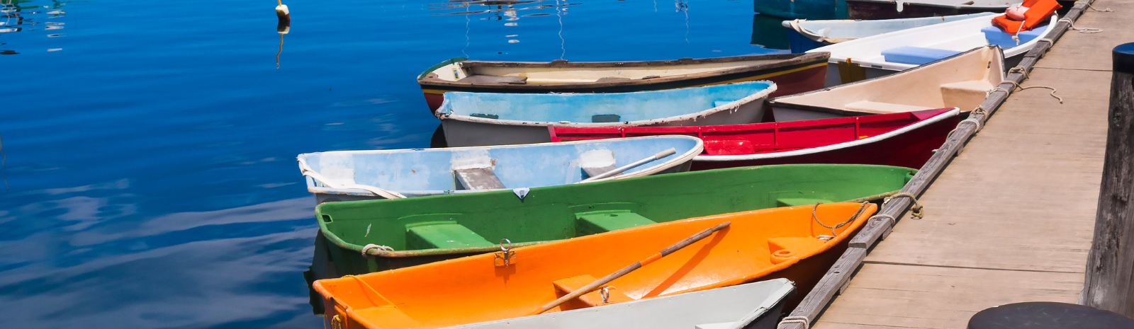 Rockport multiple colorful boats tied up to the dock.