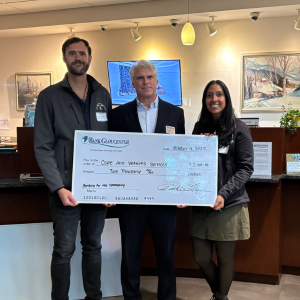 Bank Gloucester president presenting a check to fifth place winner Cape Ann Veterans Services at the 2025 Banking for the Community event.