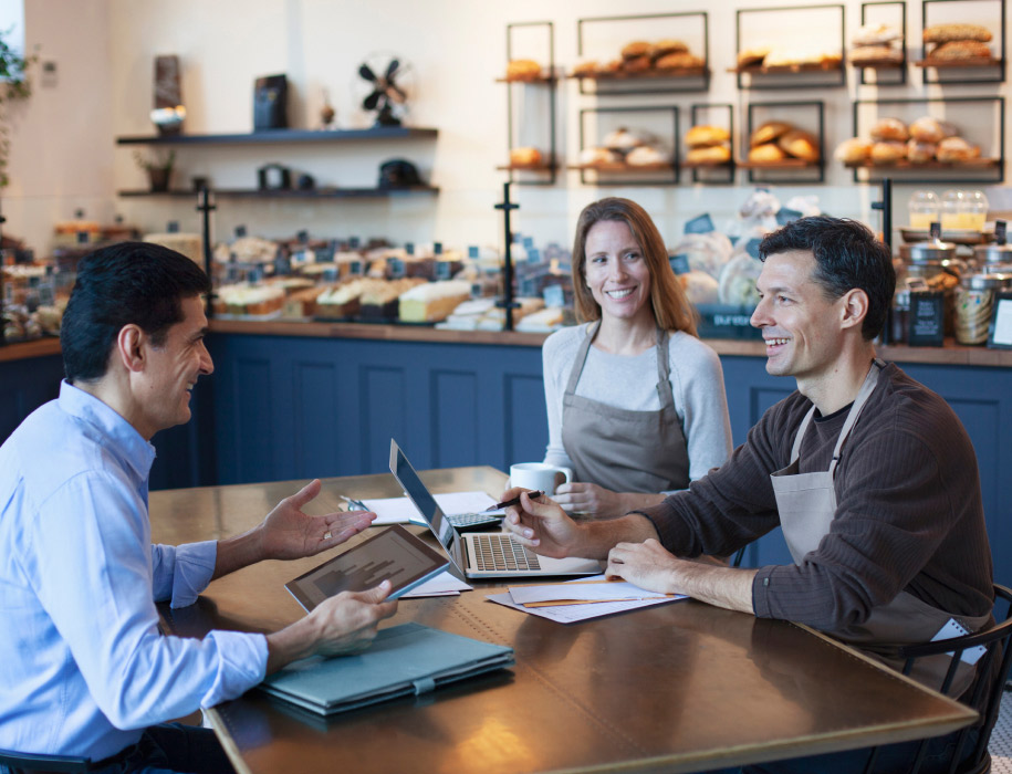 business meeting in a coffee shop between business man coffee shop owner