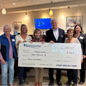 2025 Banking for the Community third place winners Generous Gardeners. BankGloucester president presenting the Generous Gardeners team a check.